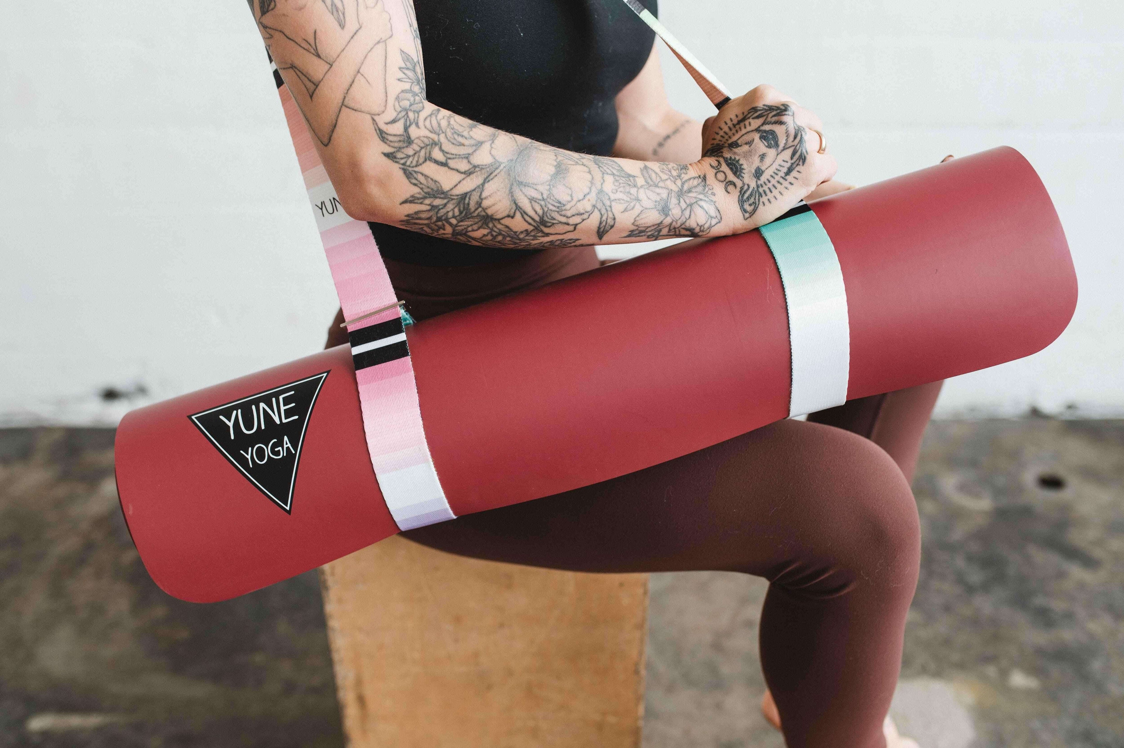 Person holding a yoga mat, highlighting the importance of health and wellness in daily fitness routines.